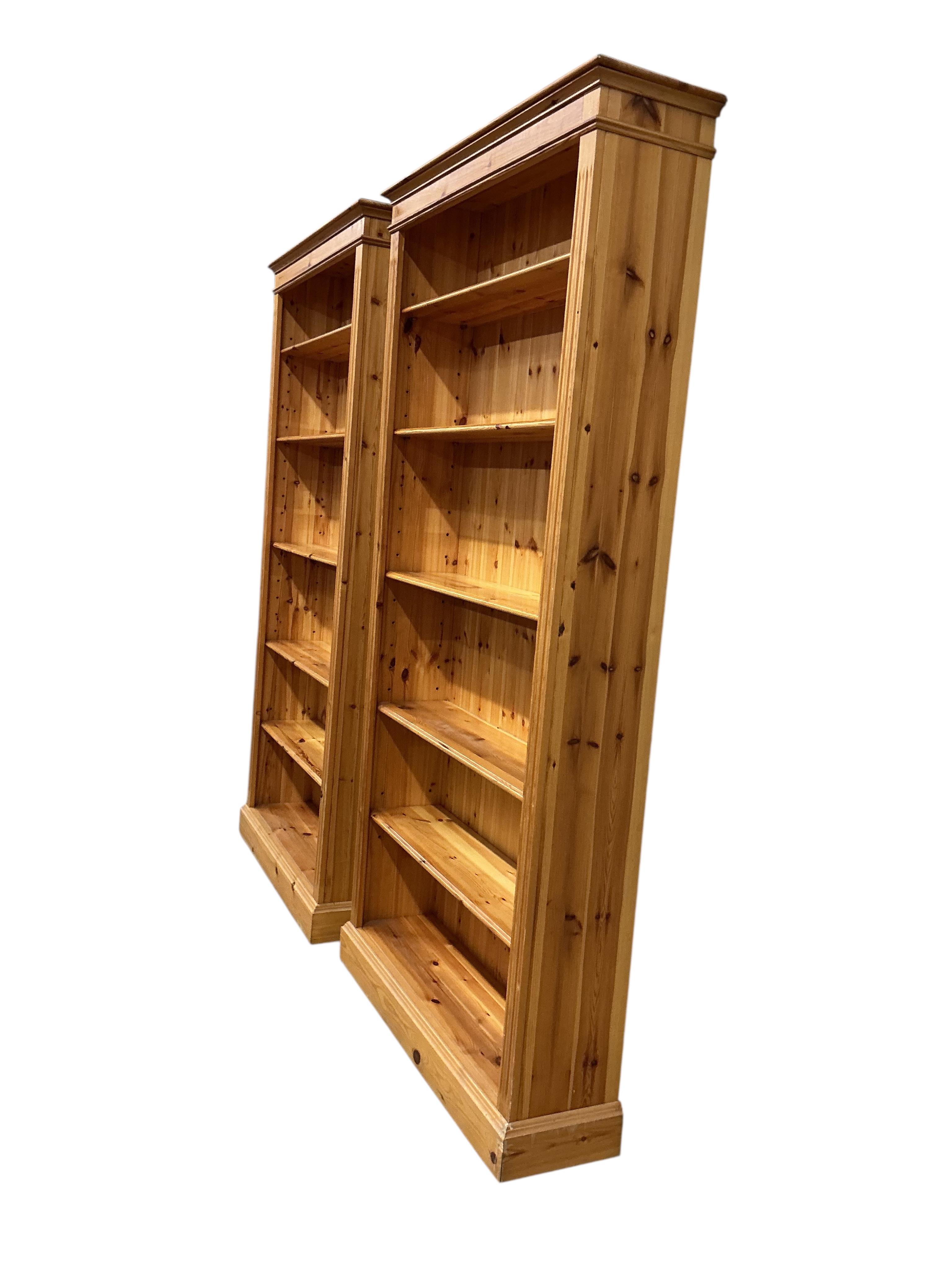 A pair of modern pine open bookcases, width 109cm, depth 29cm, height 212cm